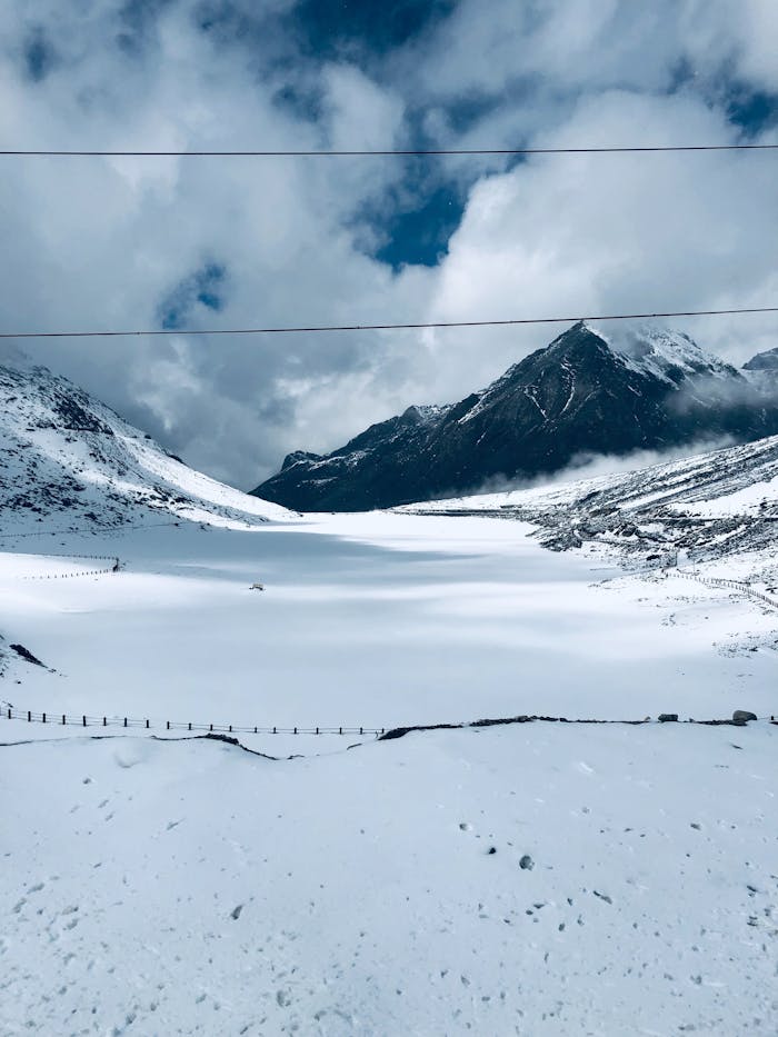 Captivating winter landscape from Tawang featuring snow-clad peaks and a serene valley.